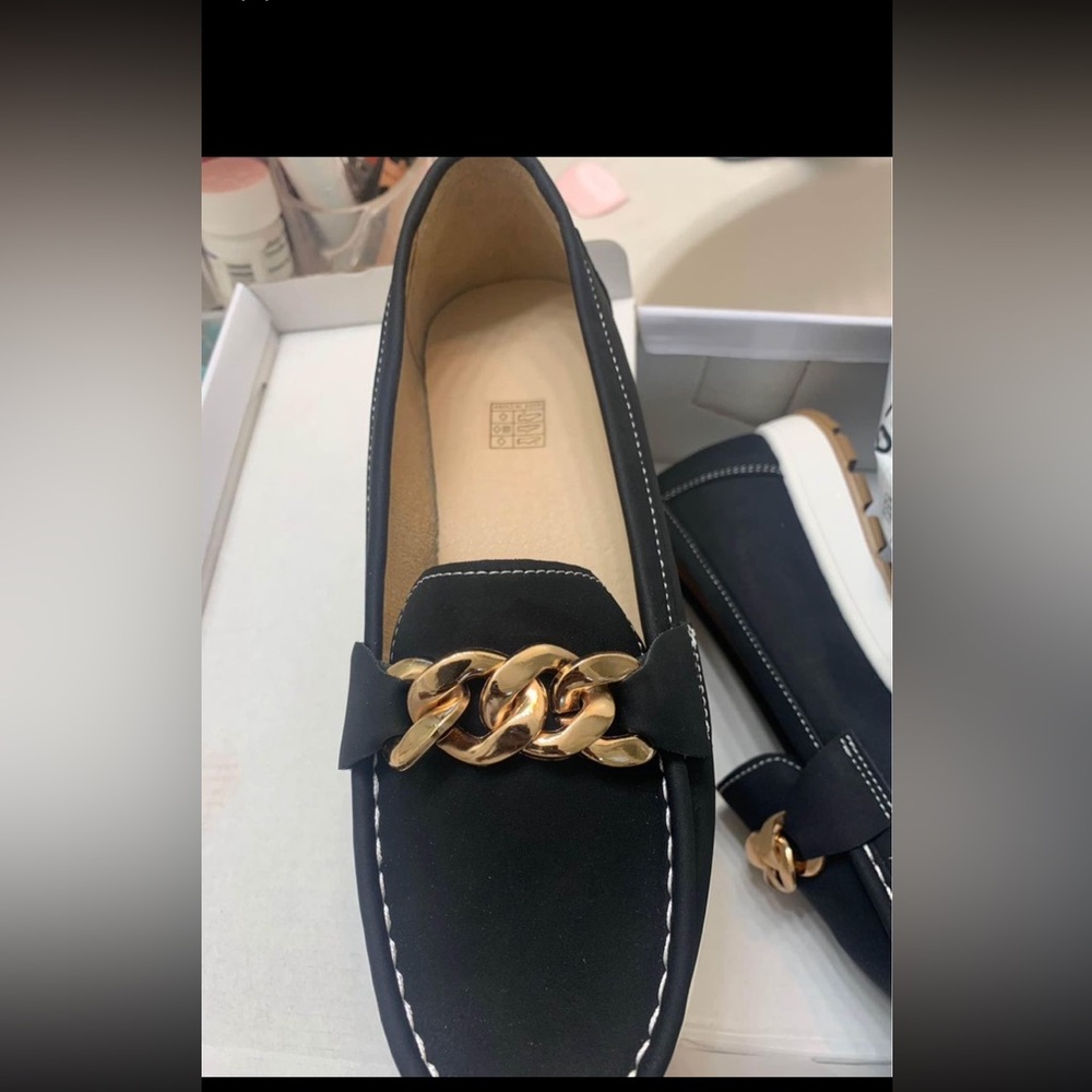 Black shoes ordered from tick tick shop . They are the wrong size